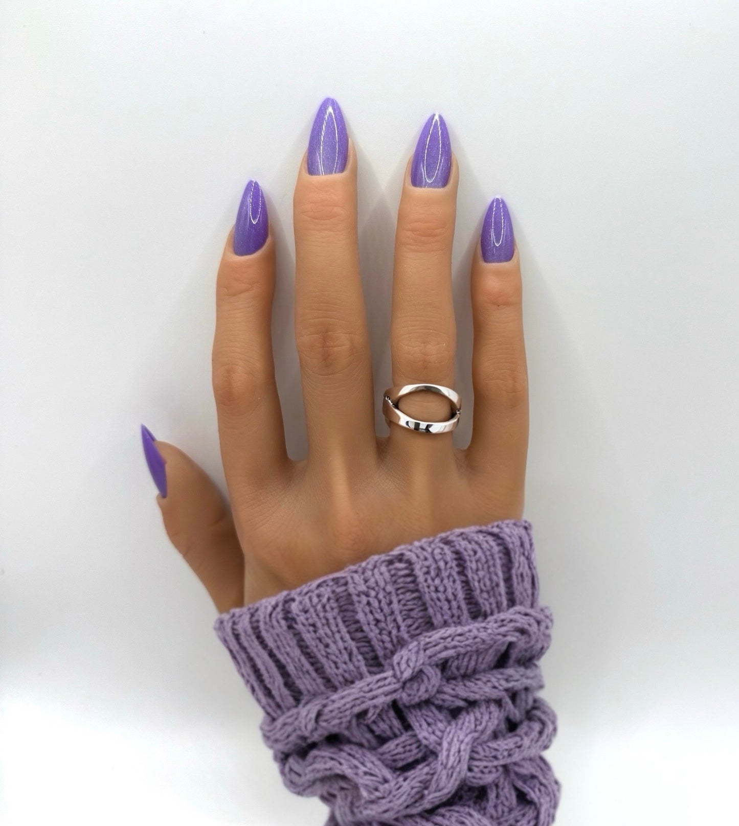 Model wearing Purple Luxe press-on nails – medium almond shape in bold metallic purple with shimmer finish