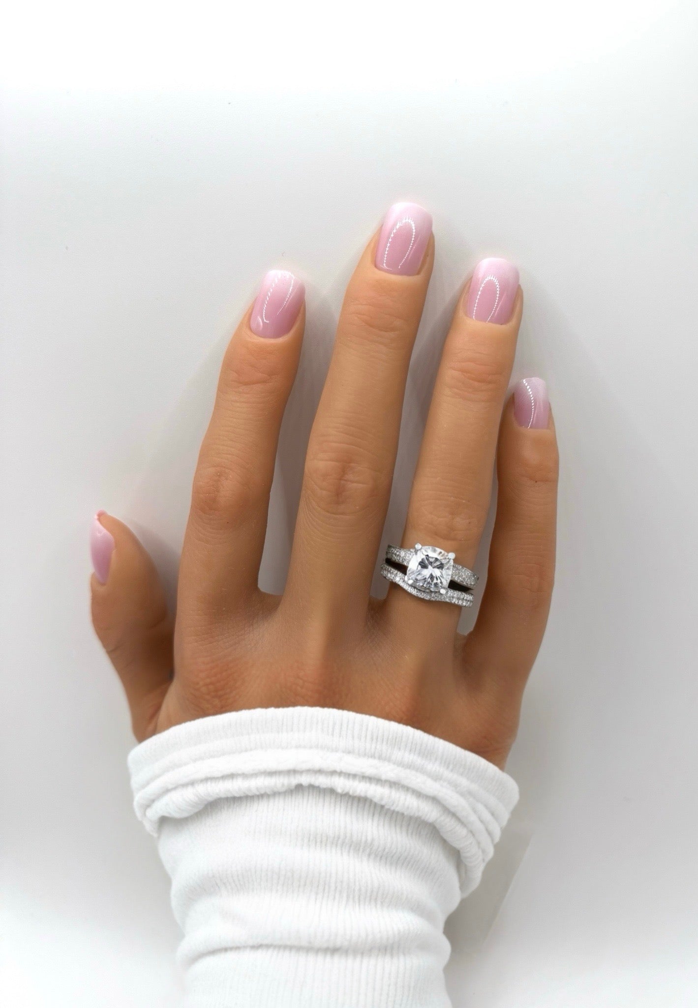 Hand wearing Subtle Pink Ombre press-on nails – short square shape with soft pink gradient finish