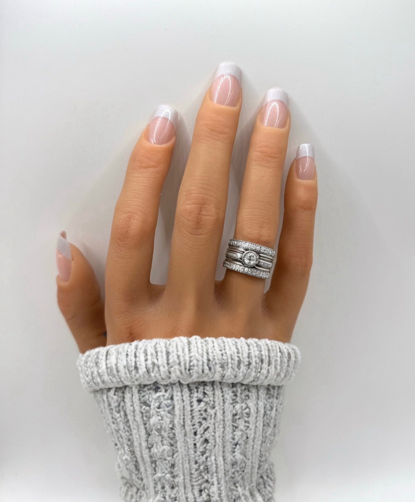 Hand wearing French Frost press-on nails – medium square nails with sheer pink base and frosted white tips