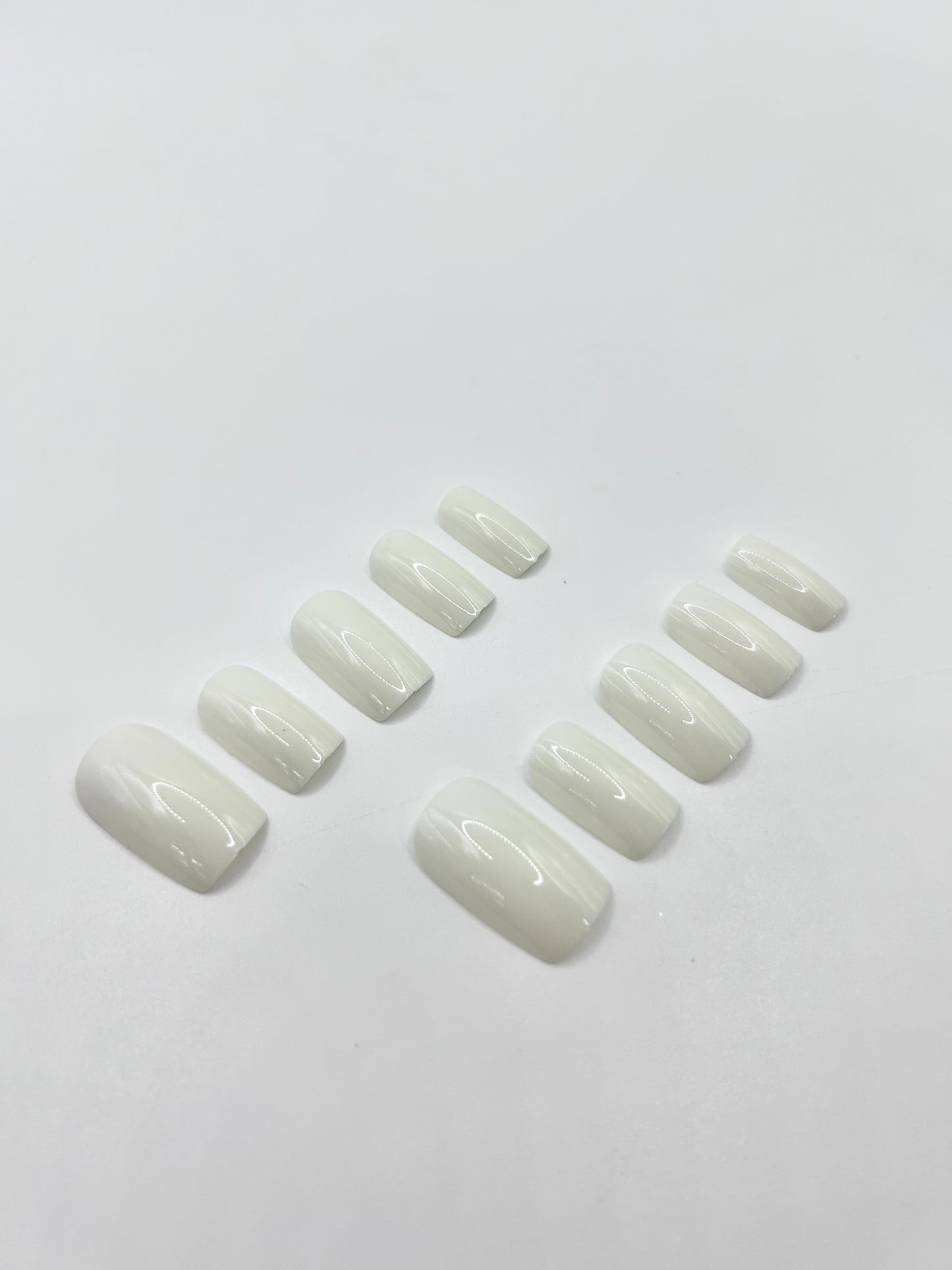 White Out press-on nails close-up – glossy white medium-length nails by Mani in Minutes