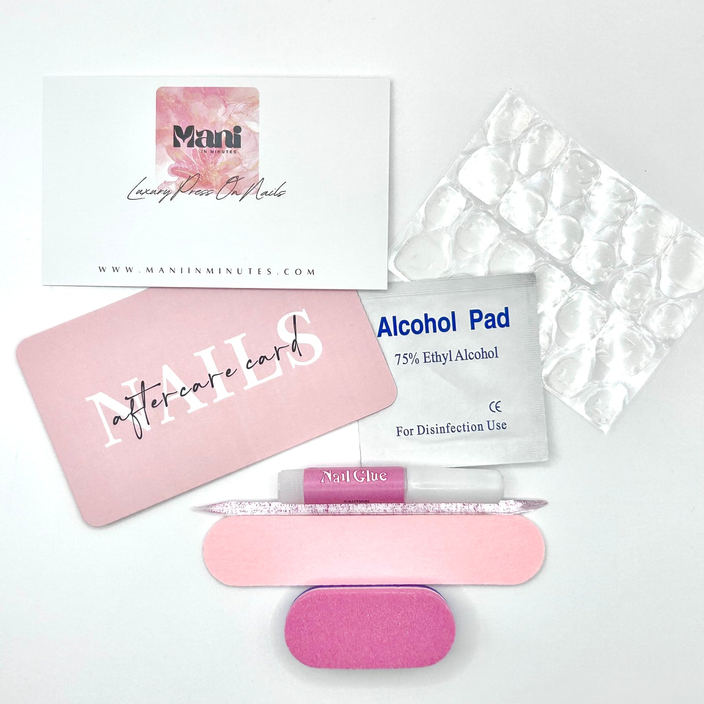 Mani in Minutes nail prep kit with glue, sticky tabs, mini file, buffer, alcohol wipe, and cuticle stick