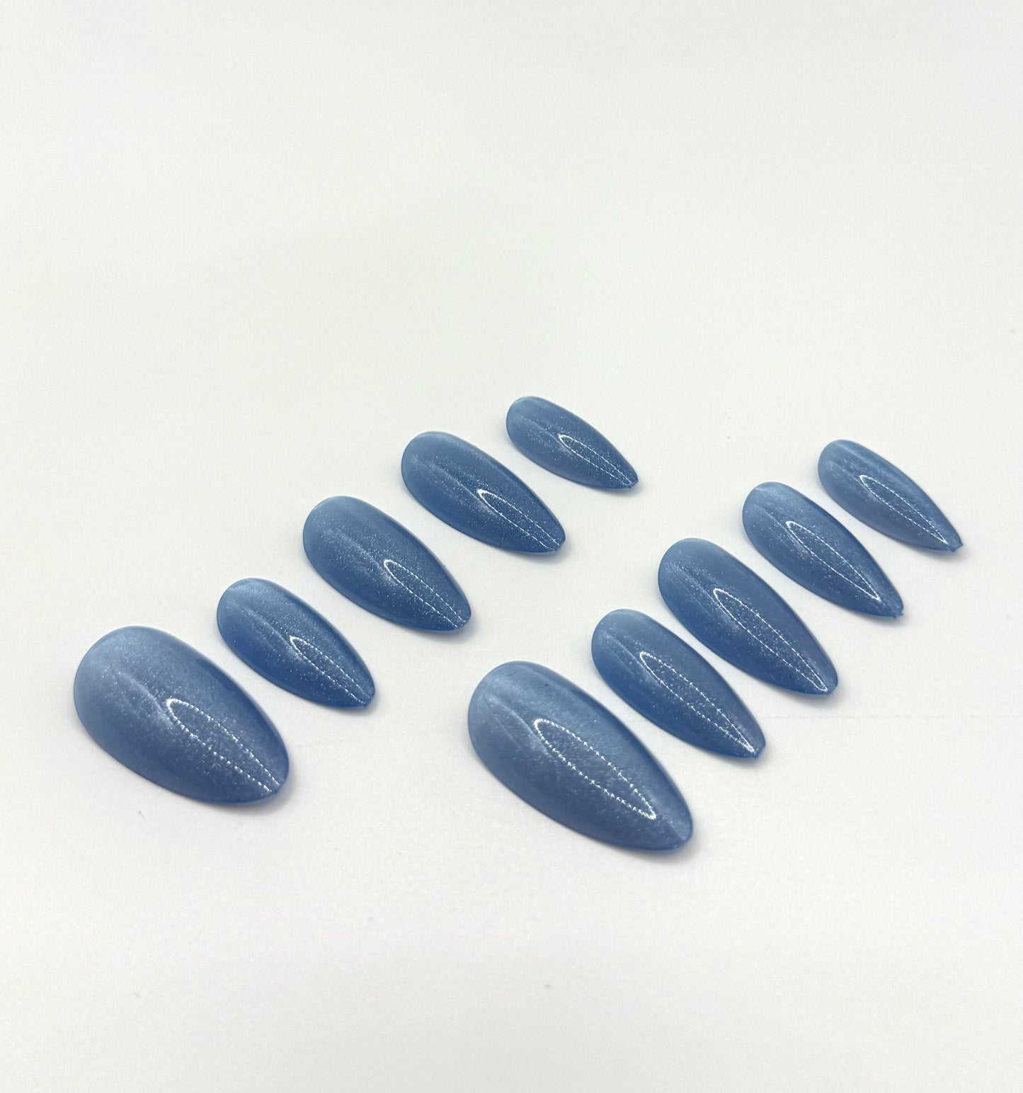 Close-up view of denim blue medium almond nails in the Blue Jean Baby set.