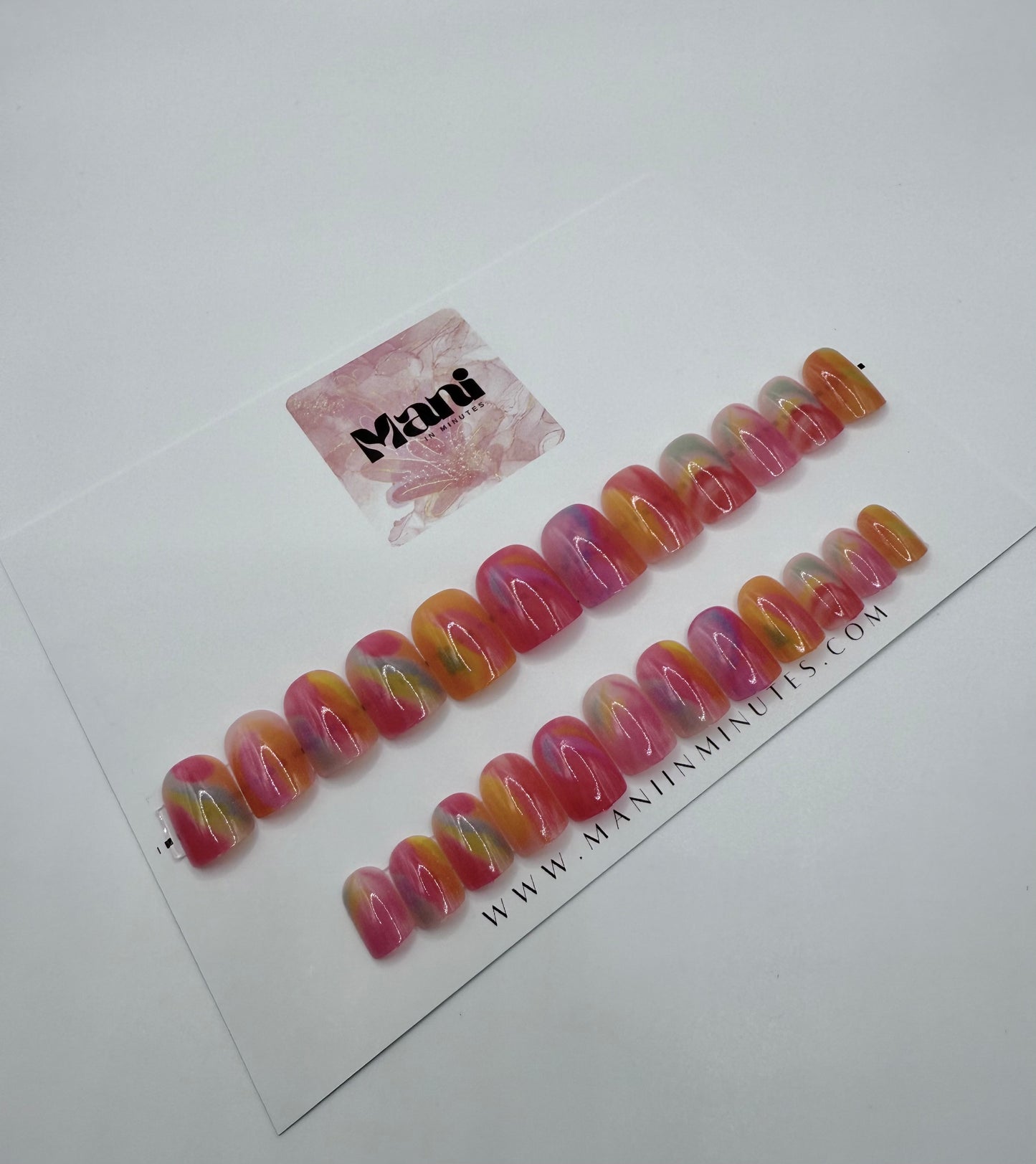 Candy Drop pastel rainbow press-on nails displayed on Mani in Minutes branded card.