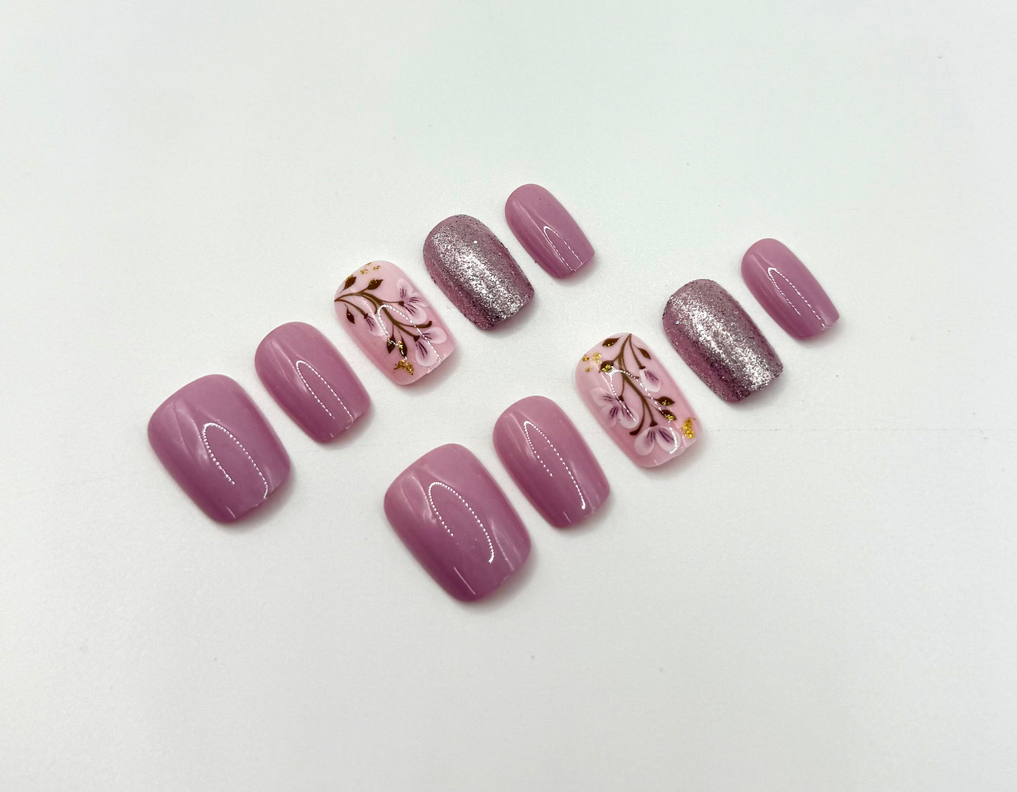 Close-up of Heirloom Rose press-on nails showing soft blush pink colour and light-reflective shimmer