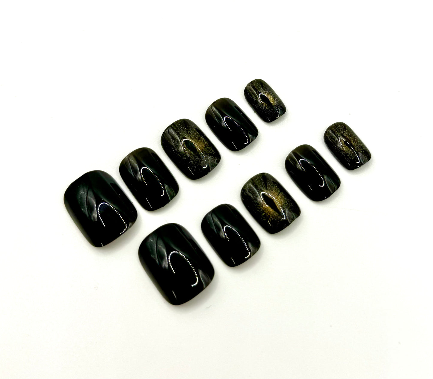 Close-up of Cat Eye press-on nails showing magnetic shimmer accents that resemble a glowing cat’s eye