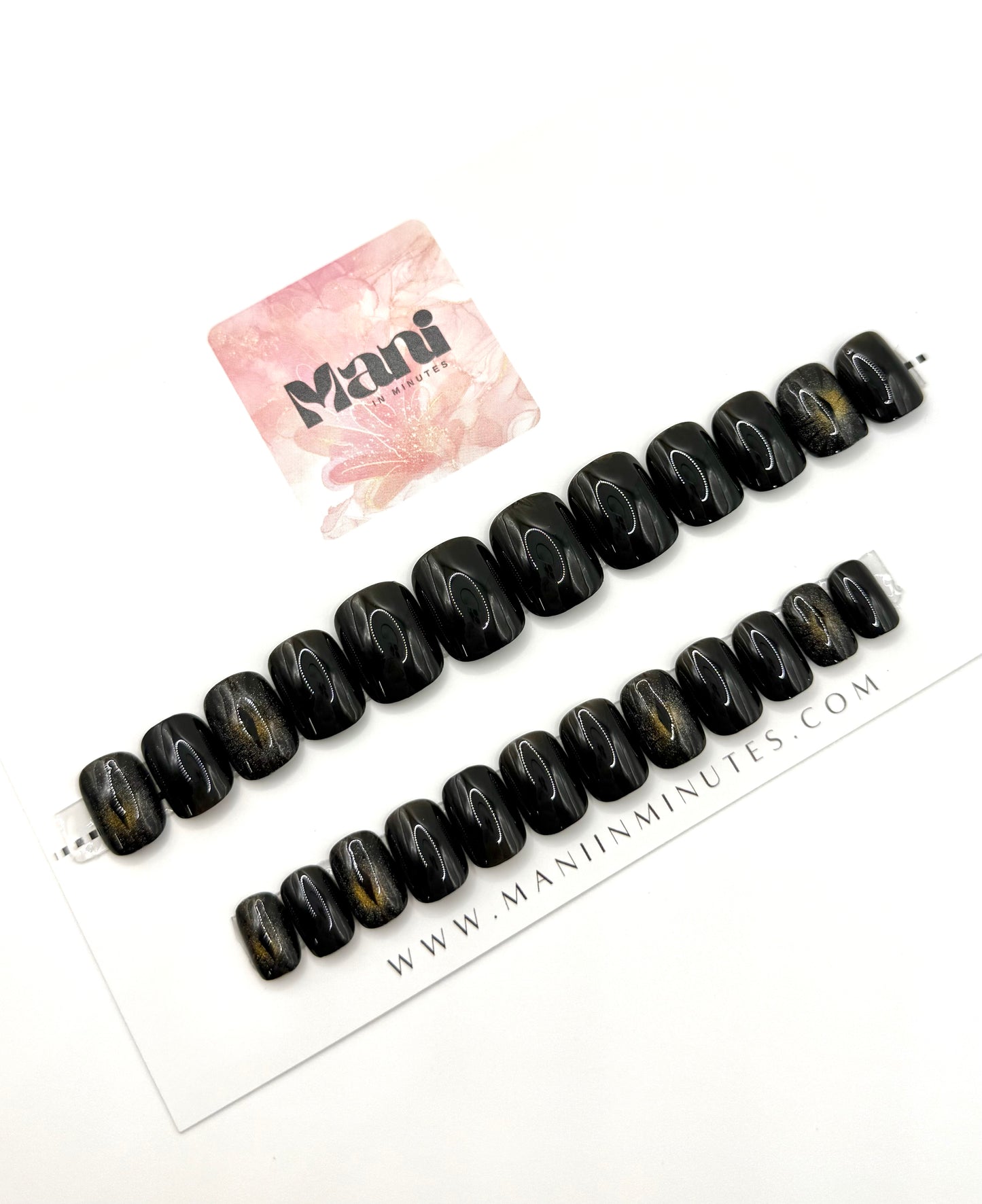 Cat Eye nail set displayed on Mani in Minutes card – glossy black short square nails with cat-eye accent nails