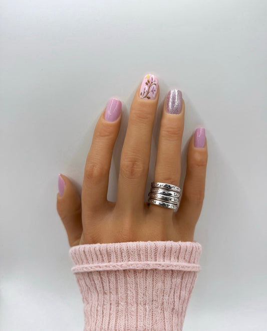Hand wearing Heirloom Rose press-on nails – medium square blush pink nails with subtle shimmer finish
