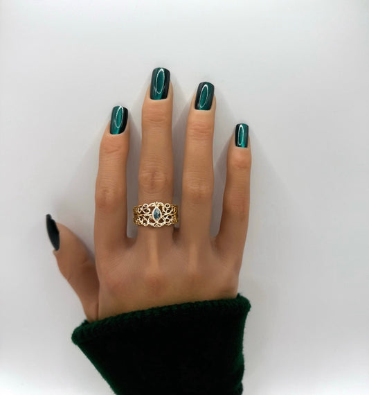 Poison Ivy medium square press-on nails shown on hand in deep green cat-eye shimmer – Mani in Minutes