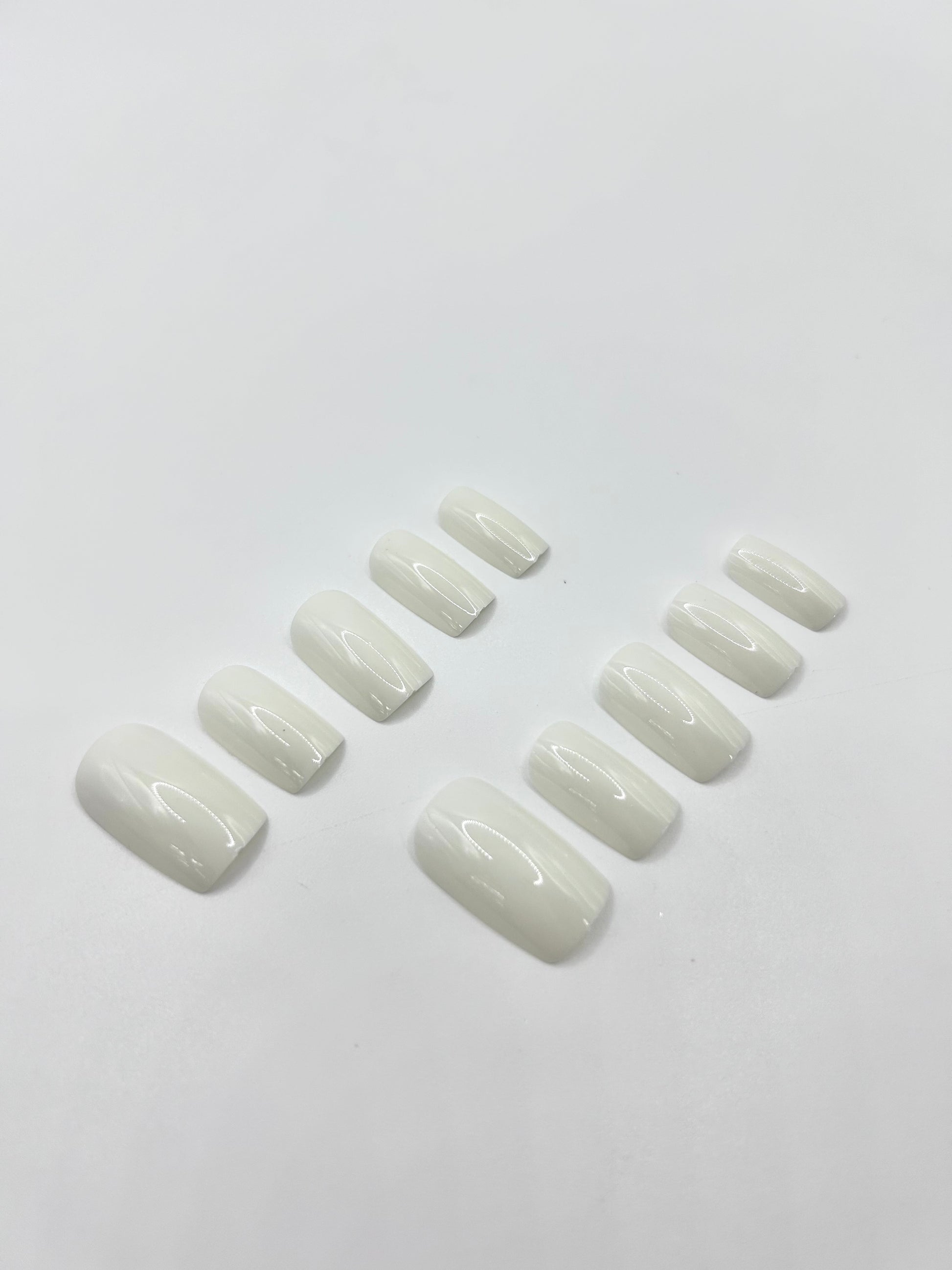 White Out press-on nails close-up – glossy white medium-length nails by Mani in Minutes

