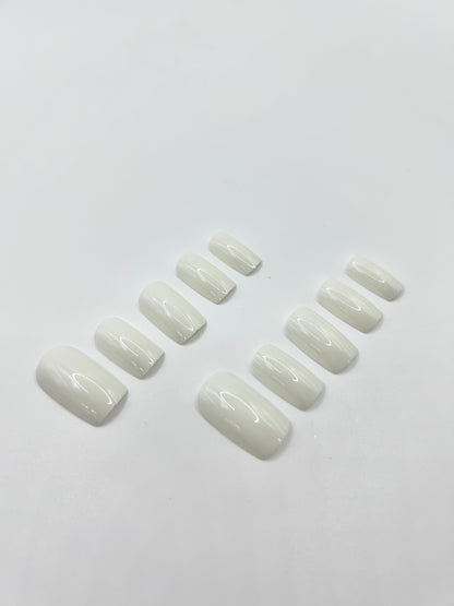 White Out press-on nails close-up – glossy white medium-length nails by Mani in Minutes
