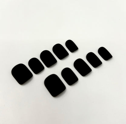 Close-up of Carbon Crush press-on nails showing sleek matte black finish