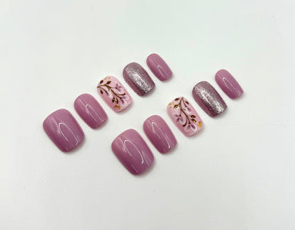 Close-up of Heirloom Rose press-on nails showing soft blush pink colour and light-reflective shimmer