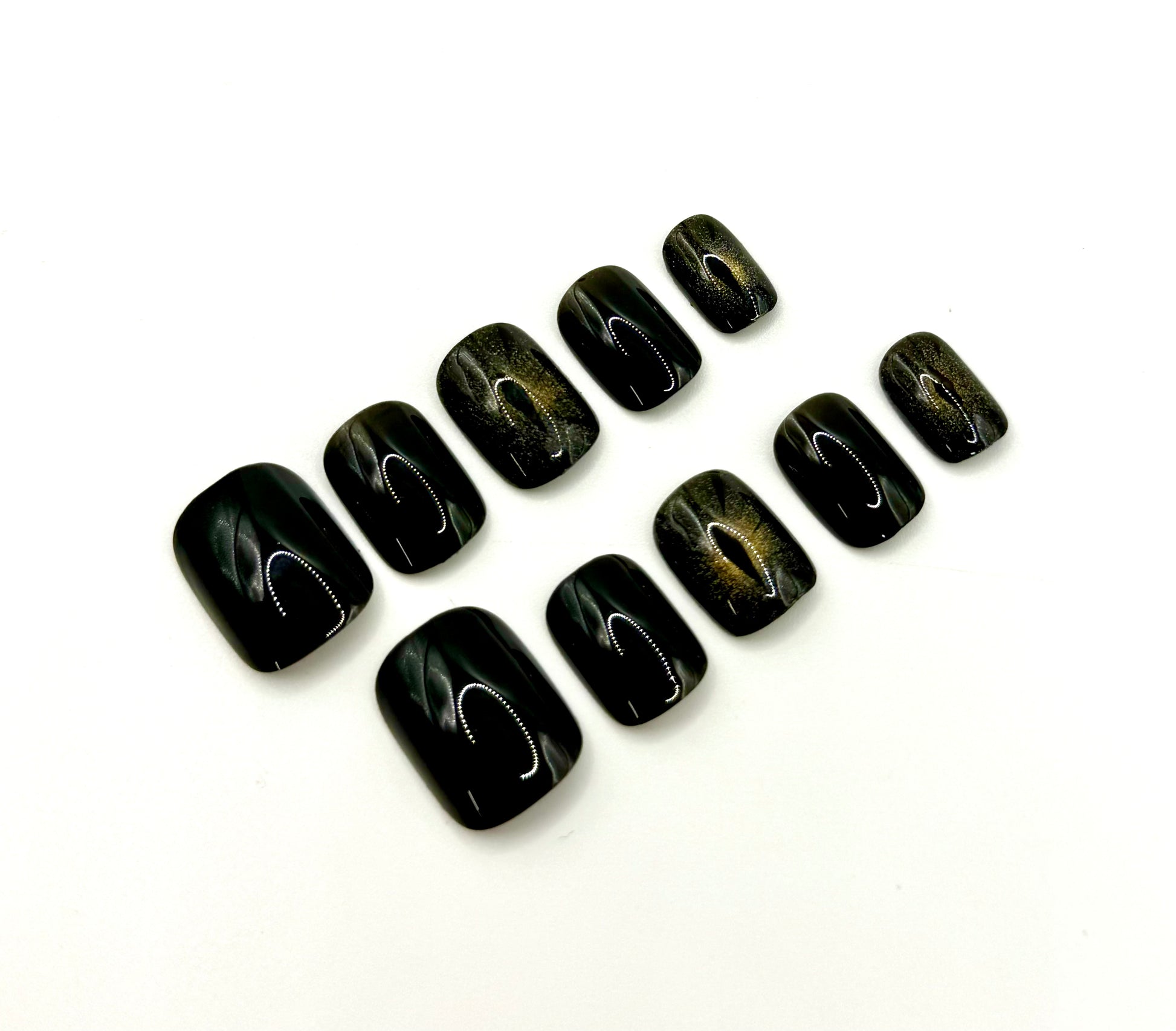 Close-up of Cat Eye press-on nails showing magnetic shimmer accents that resemble a glowing cat’s eye