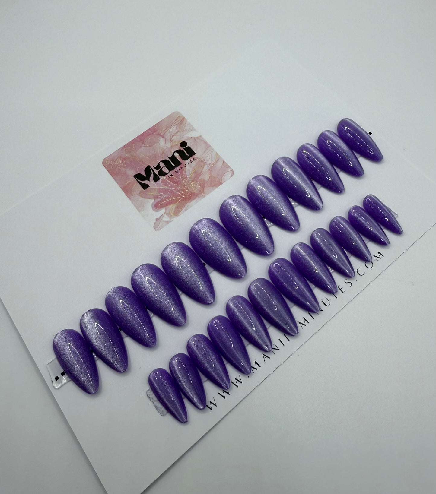 Purple Luxe press-on nails displayed on Mani in Minutes card – medium almond shape in metallic purple, assorted sizes